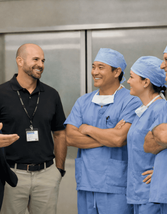 Surgical team discussing patient care with partner in hospital setting.